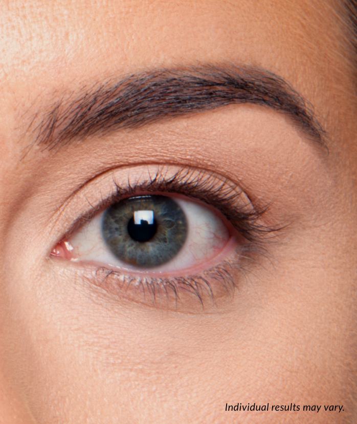 A close-up of a person's eye, showing their dark, full eyebrow and long eyelashes. The text "Individual results may vary" is in the bottom right corner.
