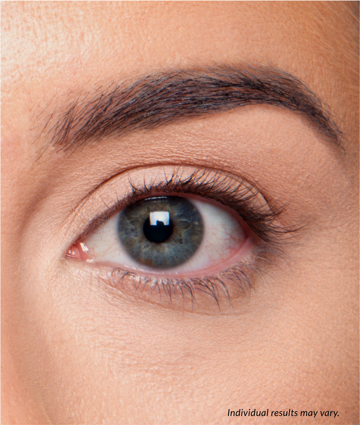 A close-up of a person's eye, showing their dark, full eyebrow and long eyelashes. The text "Individual results may vary" is in the bottom right corner.